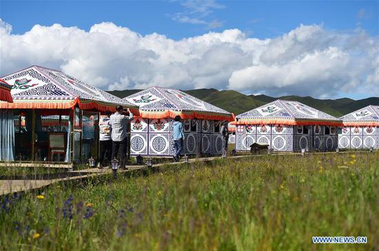 Tourists visit a tent scenic spot at Gaxiu Village of Gahai Township, Luqu County, Gannan Tibetan Autonomous Prefecture, northwest China's Gansu Province, Aug. 13, 2019. In recent years, Gannan promoted culture and tourism industry to boost income of local people. (Xinhua/Zhao Dingzhe)