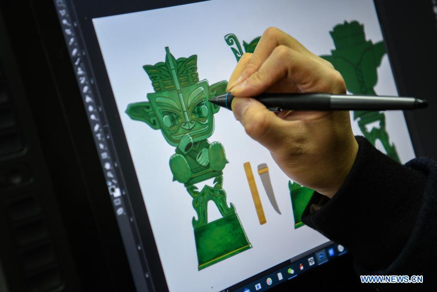 Zeng Zhou works on the design of a toy figure at a cultural industrial park in Chengdu, southwest China's Sichuan Province, Feb. 4, 2021. Zeng Zhou is a 31-year-old independent designer working on toy figure design. Inspired by a visiting experience at Sanxingdui Museum in Sichuan, Zeng decided to design model figures imitating bronze relics of the Sanxingdui Ruins, which are believed to be remnants of the Shu Kingdom dating back 2,600 years to 4,800 years, blending traditional Chinese culture with fashion toys. Zeng Zhou is now dedicated to optimizing his design and promoting mass production of his toy figures. 